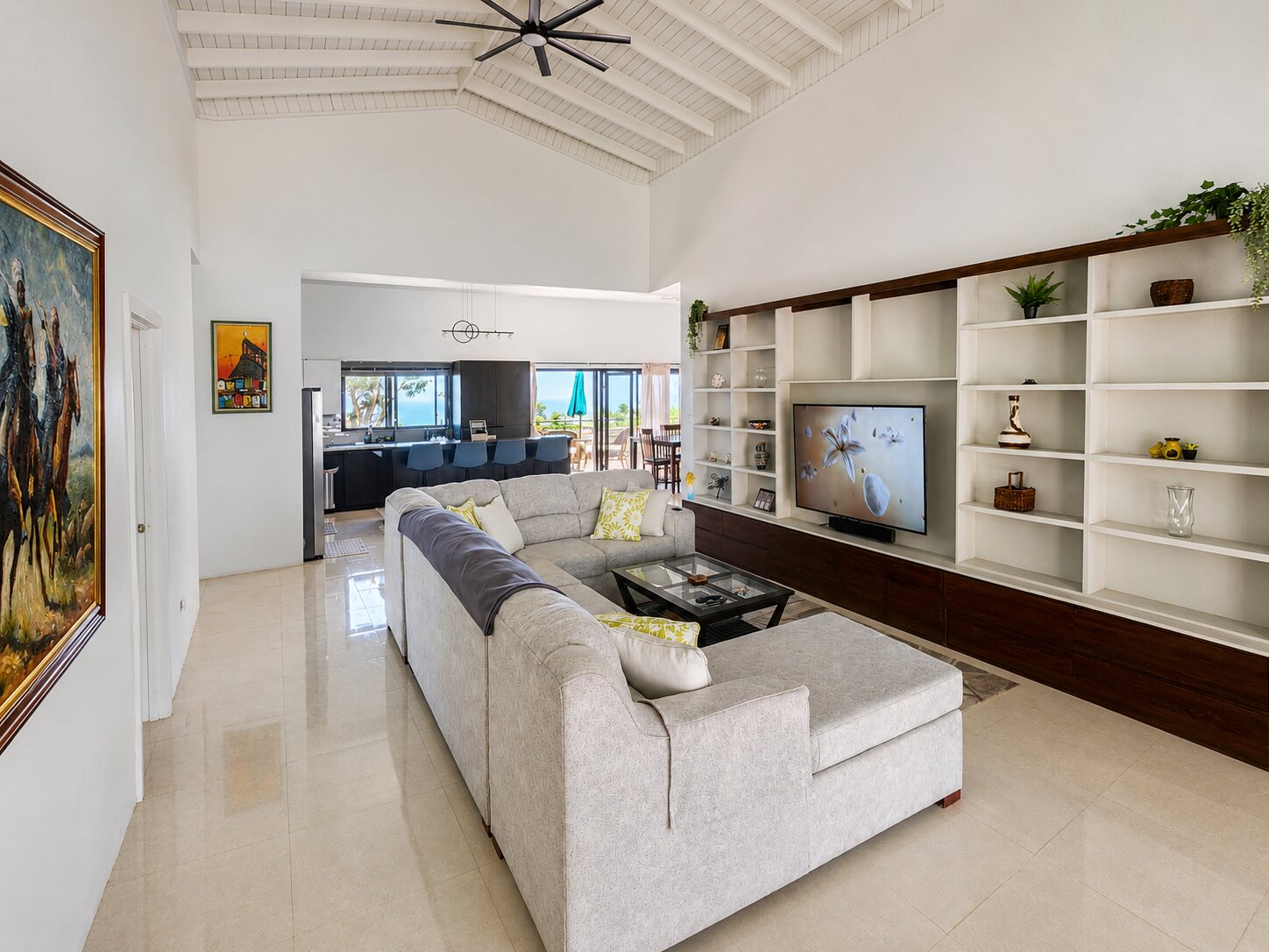 The open-plan living room with a soaring vaulted ceiling and an ocean-view sightline